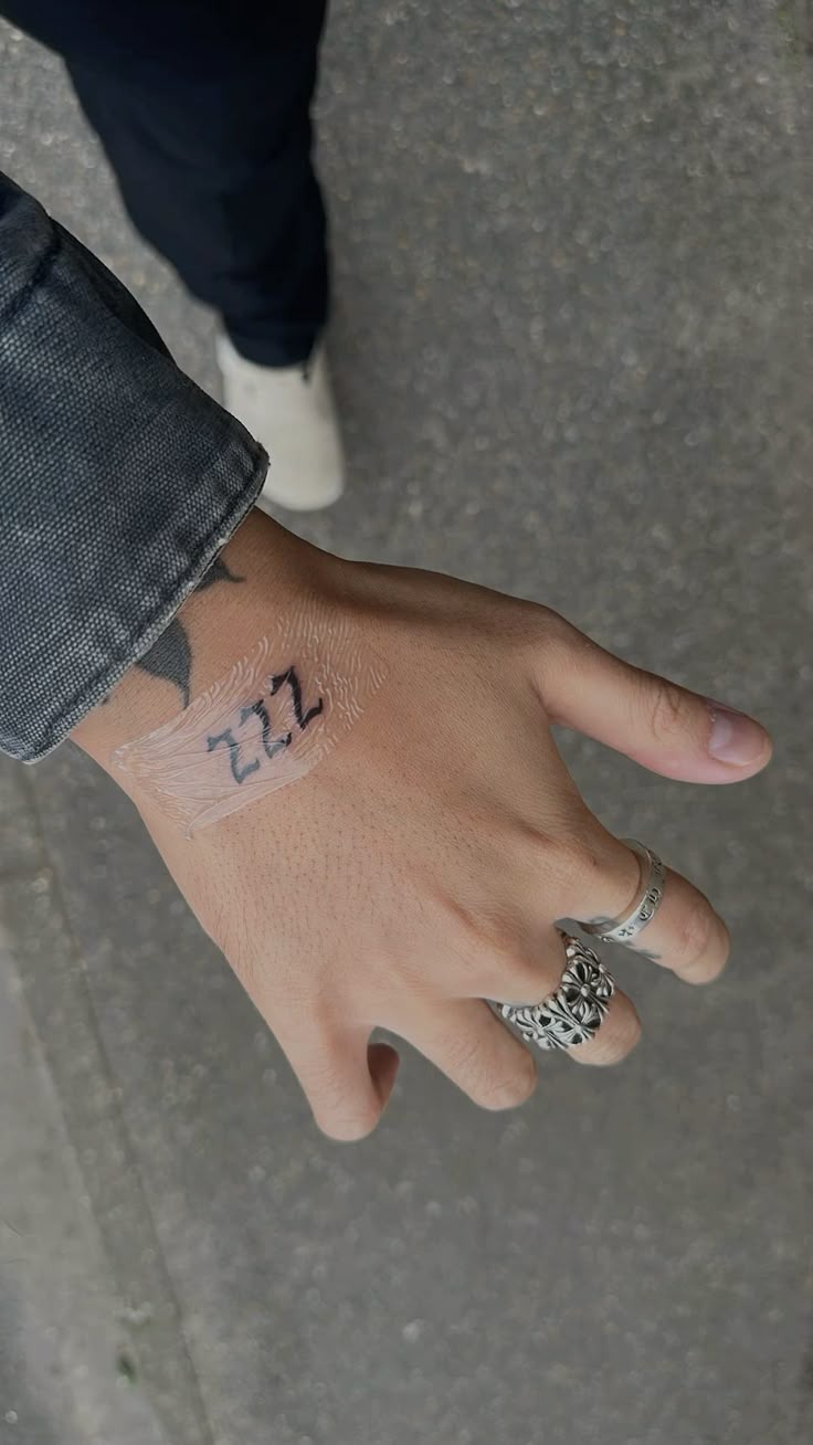 Bold Hand Placement 222, a tattoo design rendered in bold.