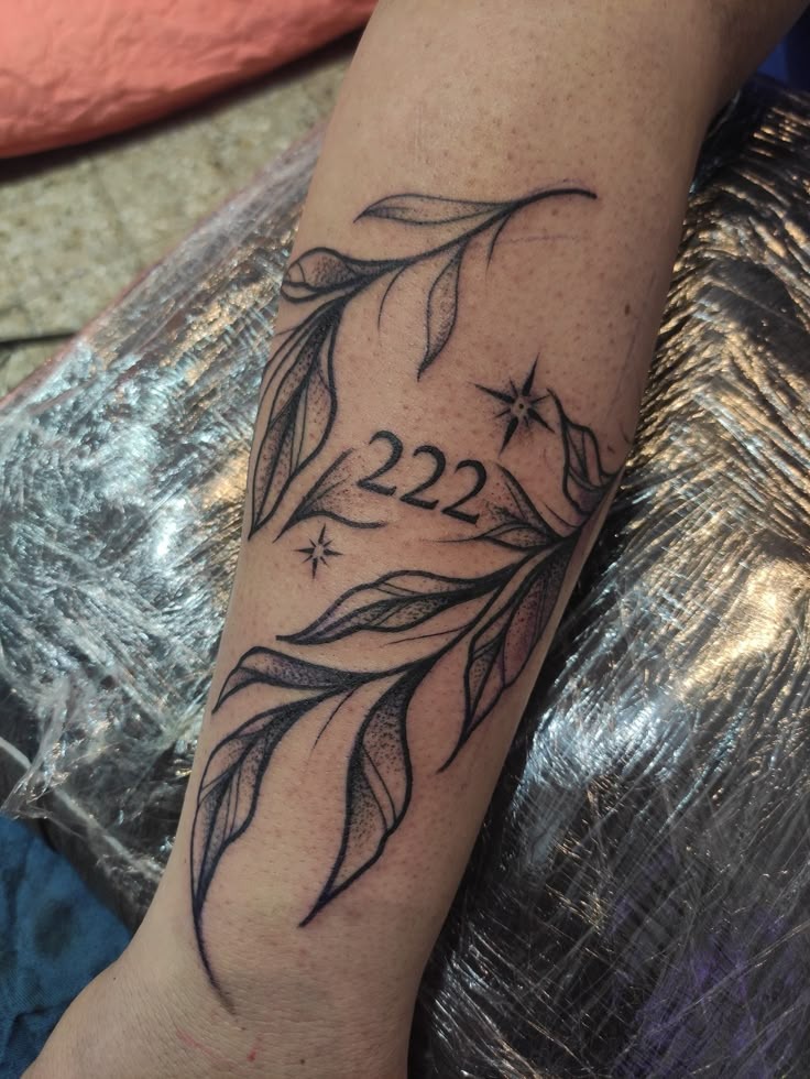 Botanical 222 with Leaves, a tattoo design rendered in clean detailed linework for the leg.