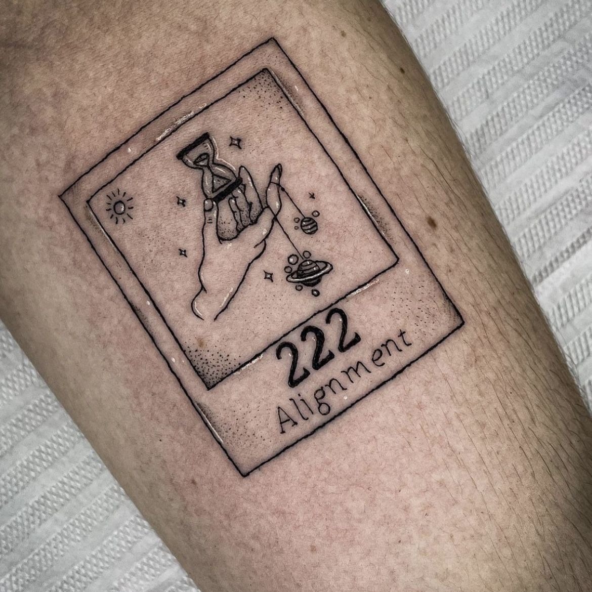 Polaroid Frame with 222 Alignment, a tattoo design rendered in clean detailed linework for the hand.