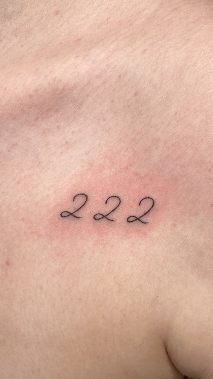 Scripted 222 on the Chest, a tattoo design rendered in clean detailed linework for the hand.