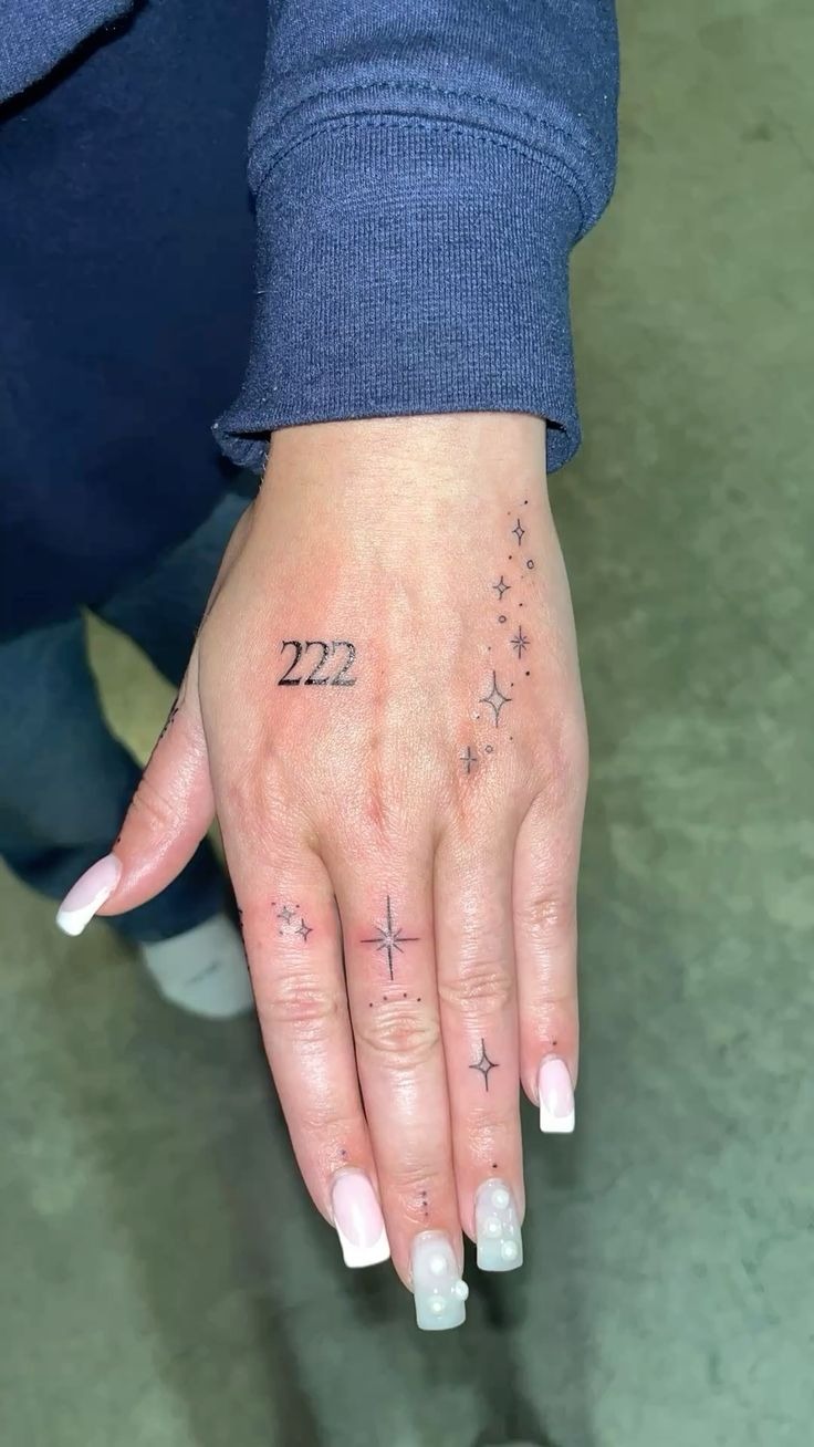 Star Cascade with 222 on the Hand, a tattoo design rendered in bold.