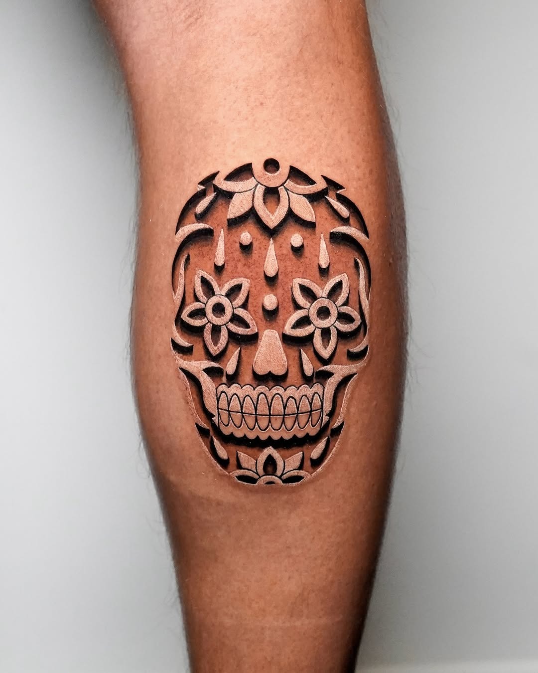 Bold 3D skull tattoo with floral elements Tattoo Design