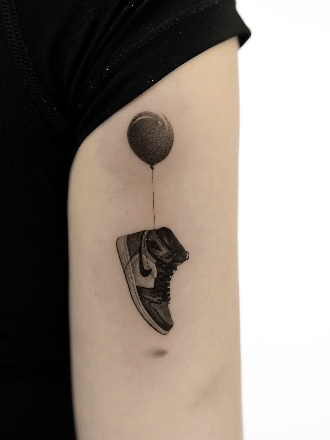 Unique sneaker tattoo with playful balloon design Tattoo Design