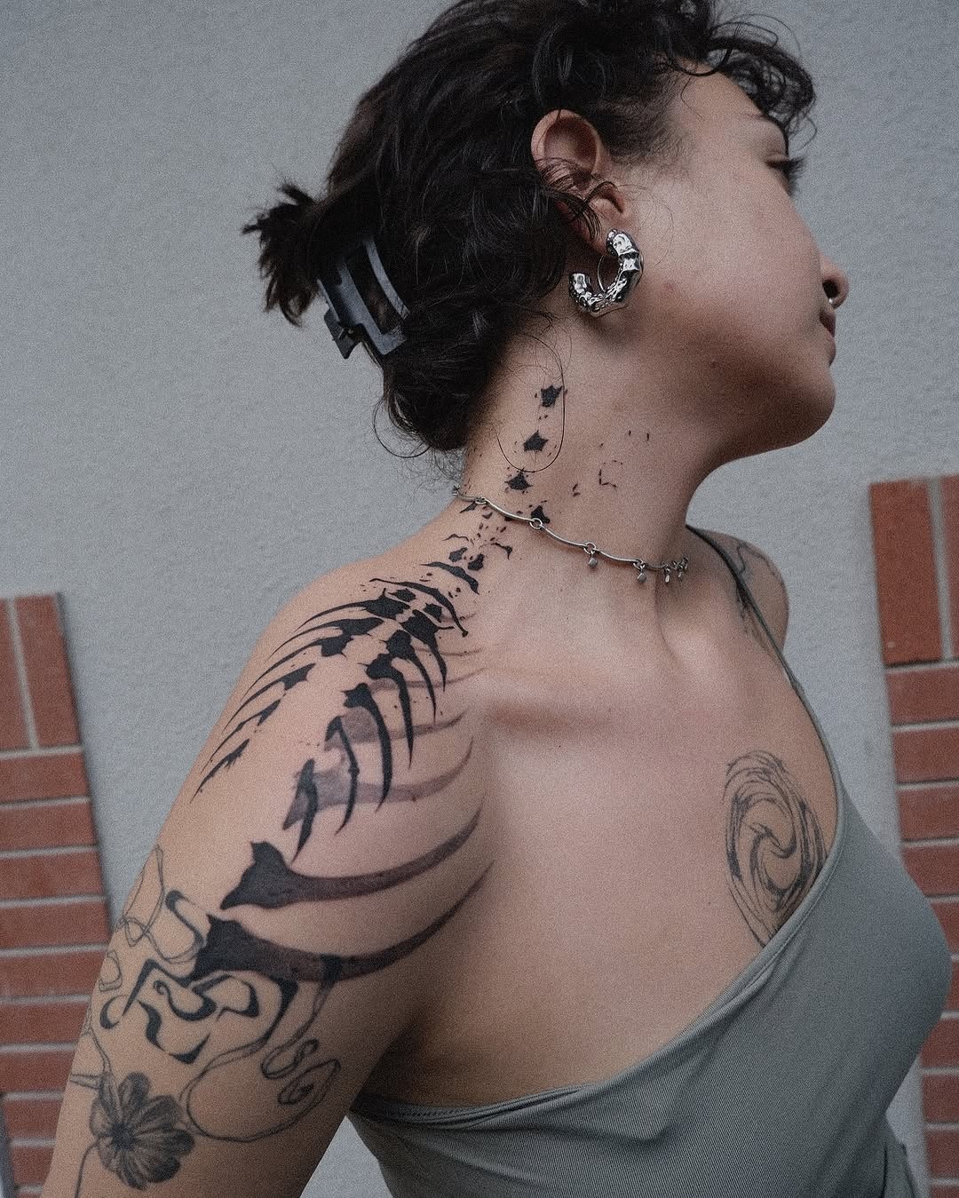 This abstract tattoo features a stunning blend of bold black ink and flowing forms, creating a unique and eye-catching appearance.