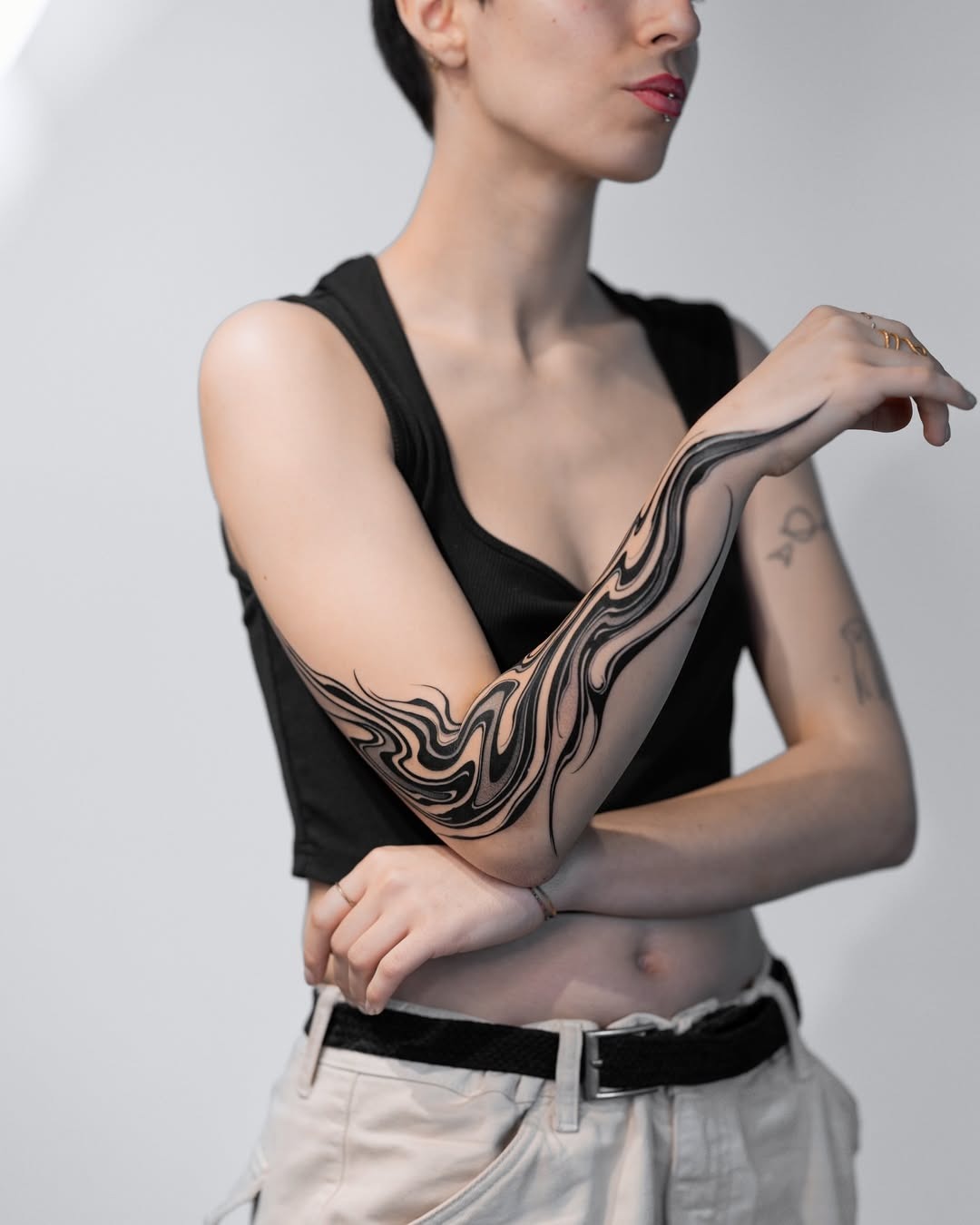 This tattoo showcases an intricate design of flowing waves, creating a sense of movement and fluidity.