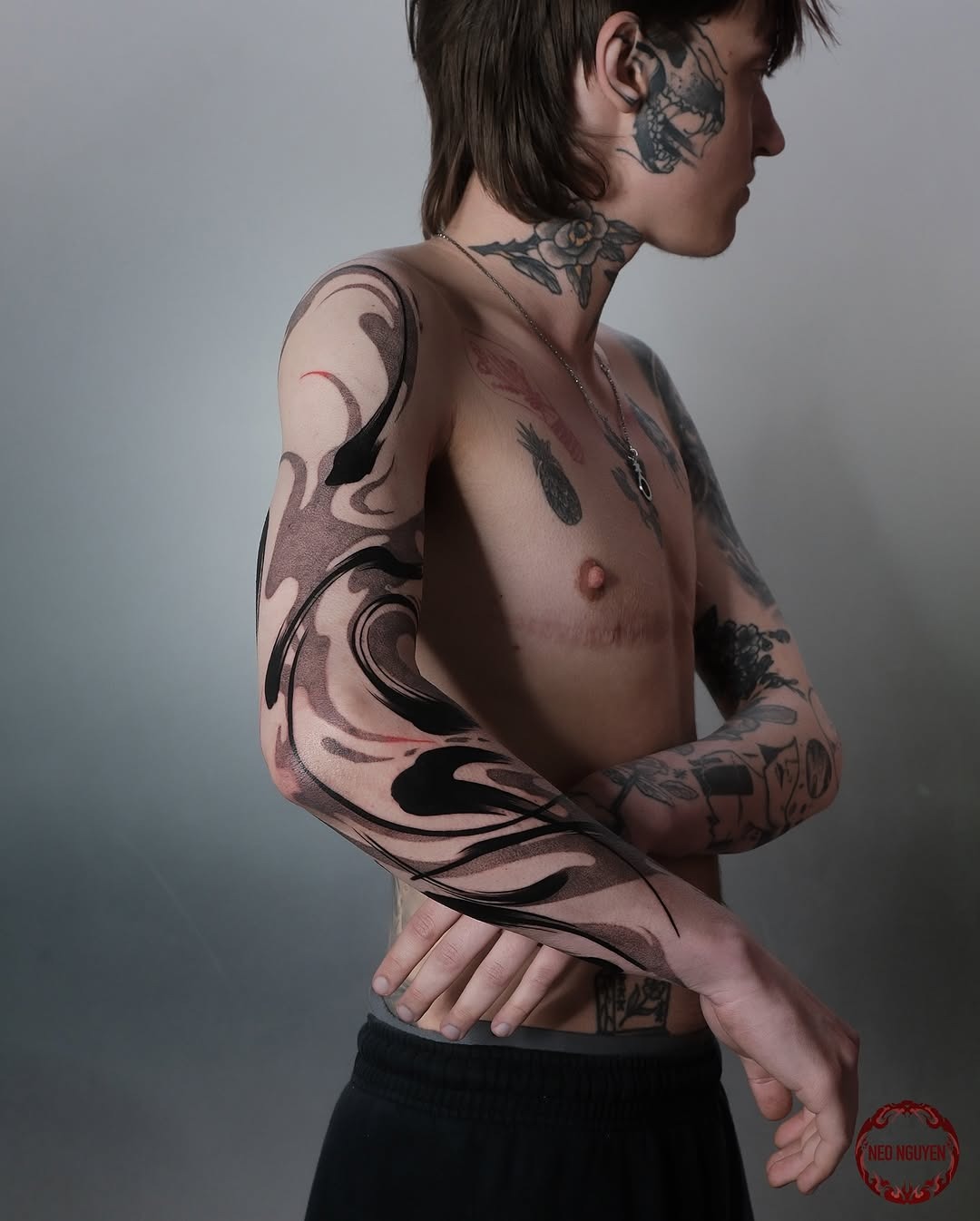 This abstract tattoo features fluid black swirls that elegantly wrap around the arm.