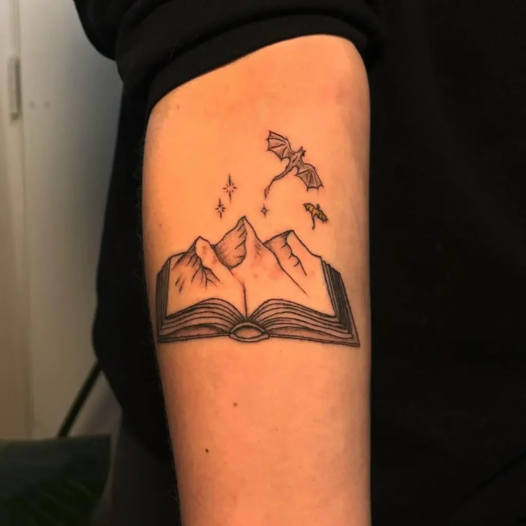 Open Book with Mountains and Dragons Tattoo Design