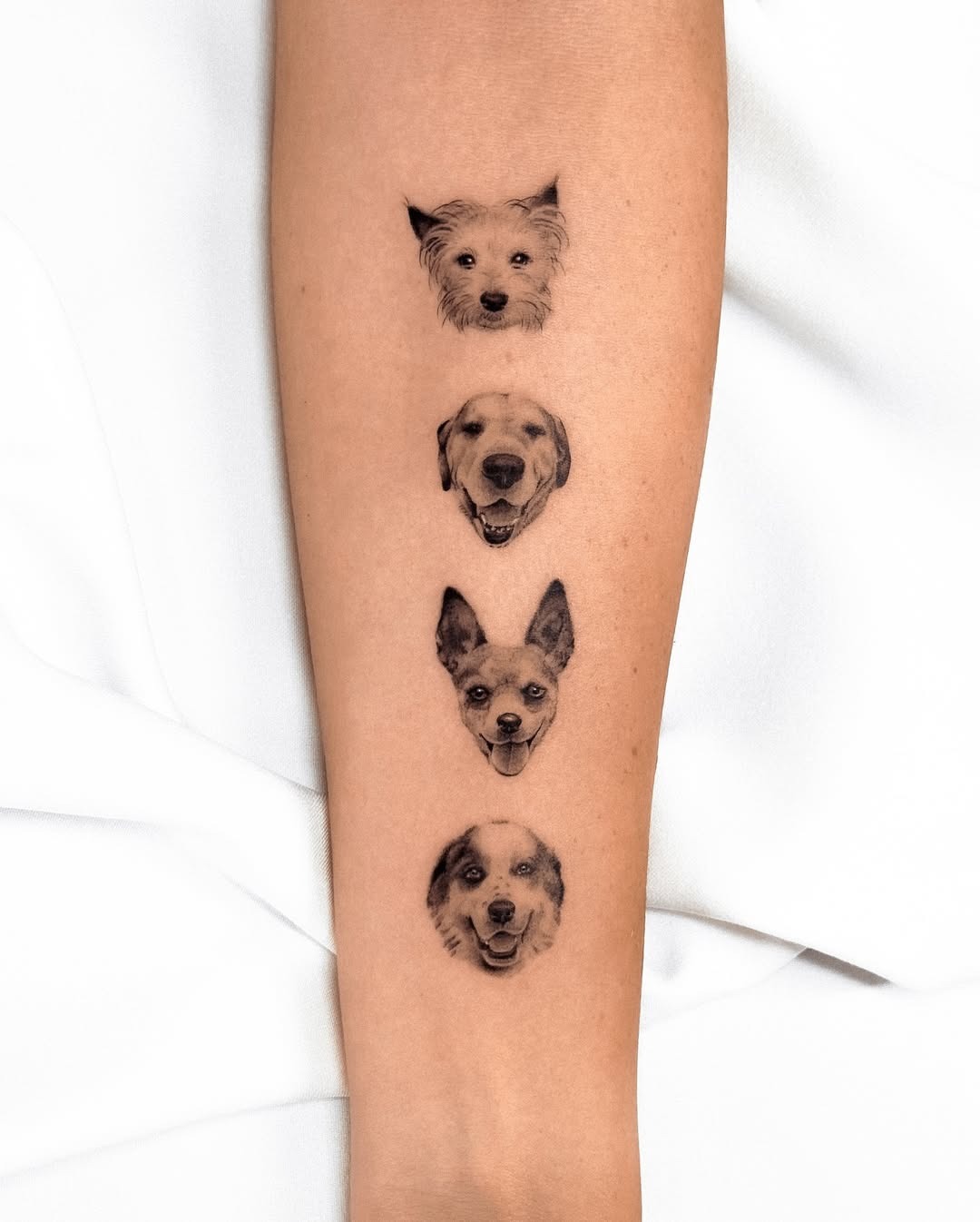 Charming Dog Faces Inked on Skin Tattoo Design