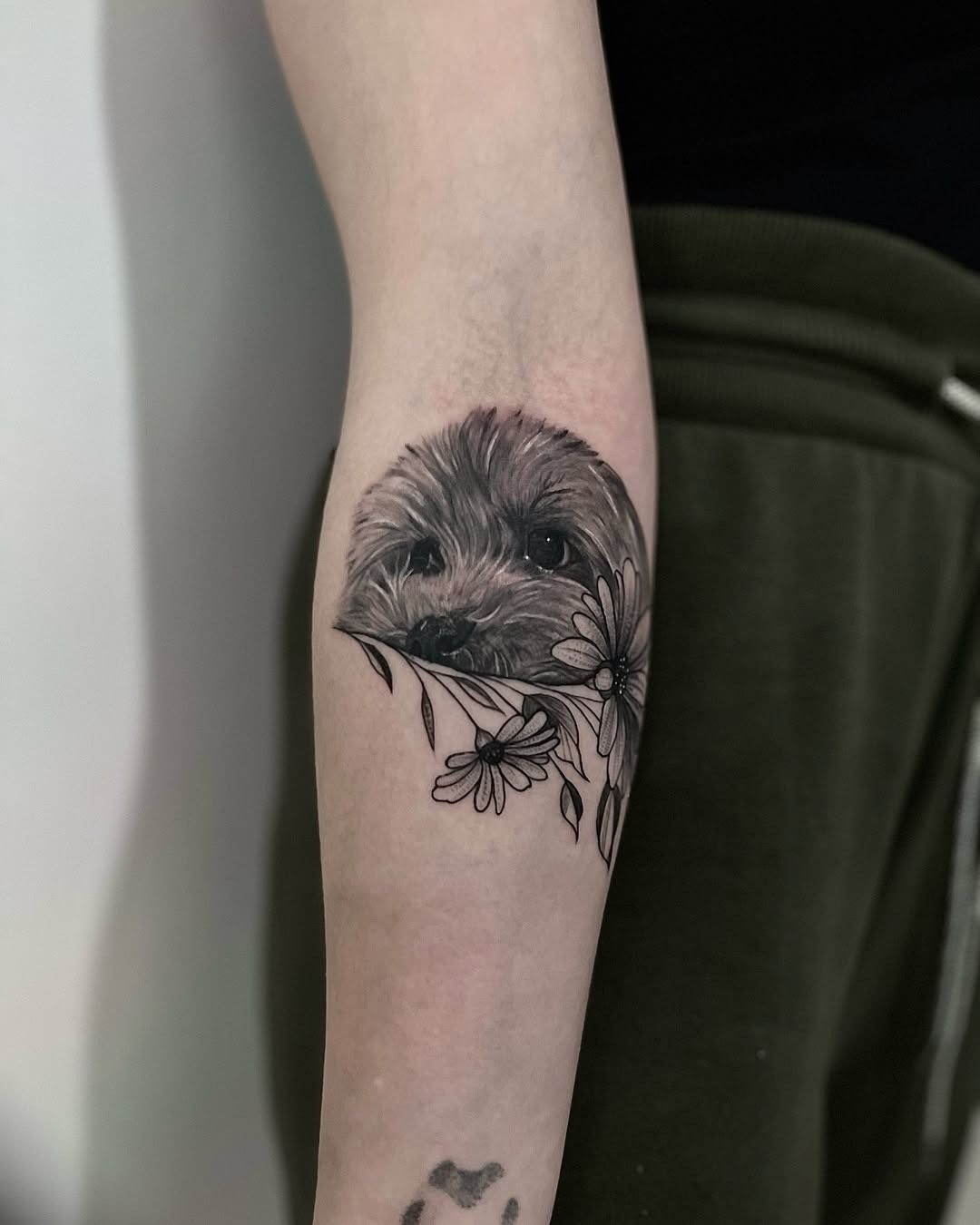 Charming dog tattoo with floral accents Tattoo Design