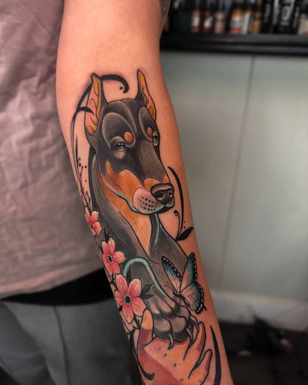 Colorful Doberman Tattoo with Floral Elements Tattoo Design