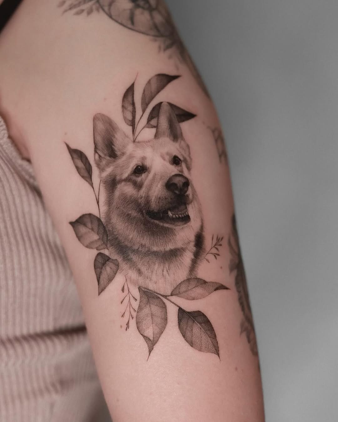 Exquisite Dog Tattoo Surrounded by Leaves Tattoo Design
