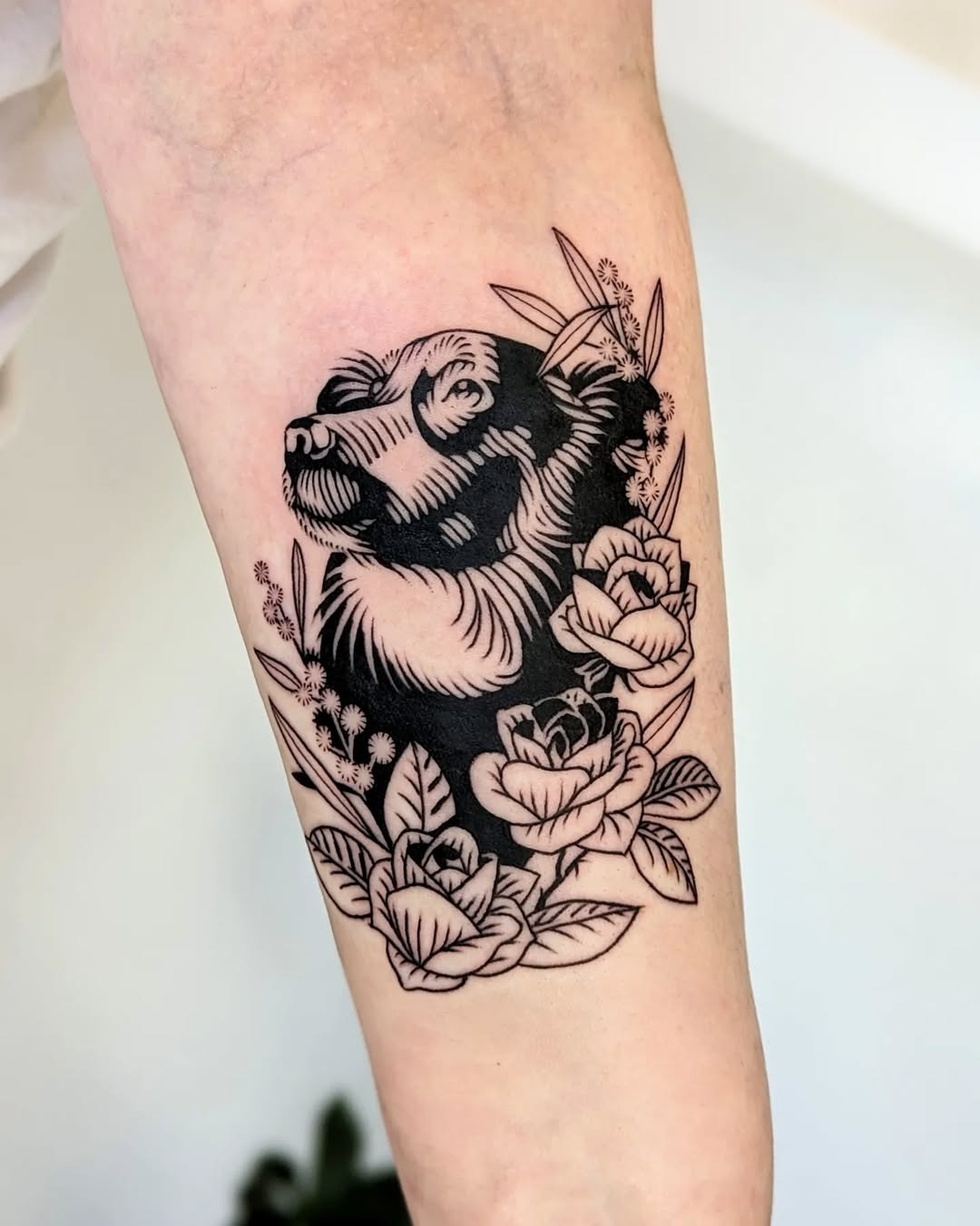 Stunning dog tattoo surrounded by roses Tattoo Design