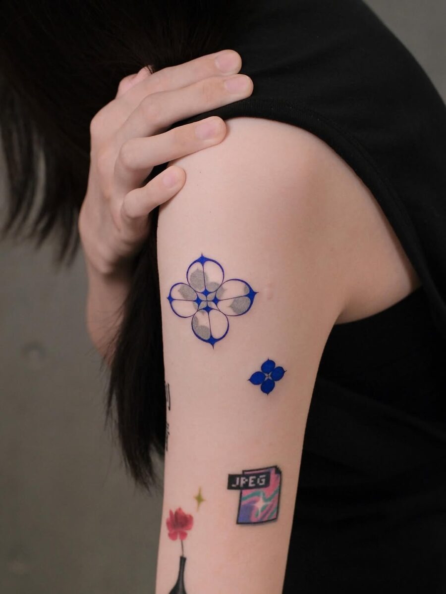 This image features stunning blue floral tattoos elegantly inked on the arm.