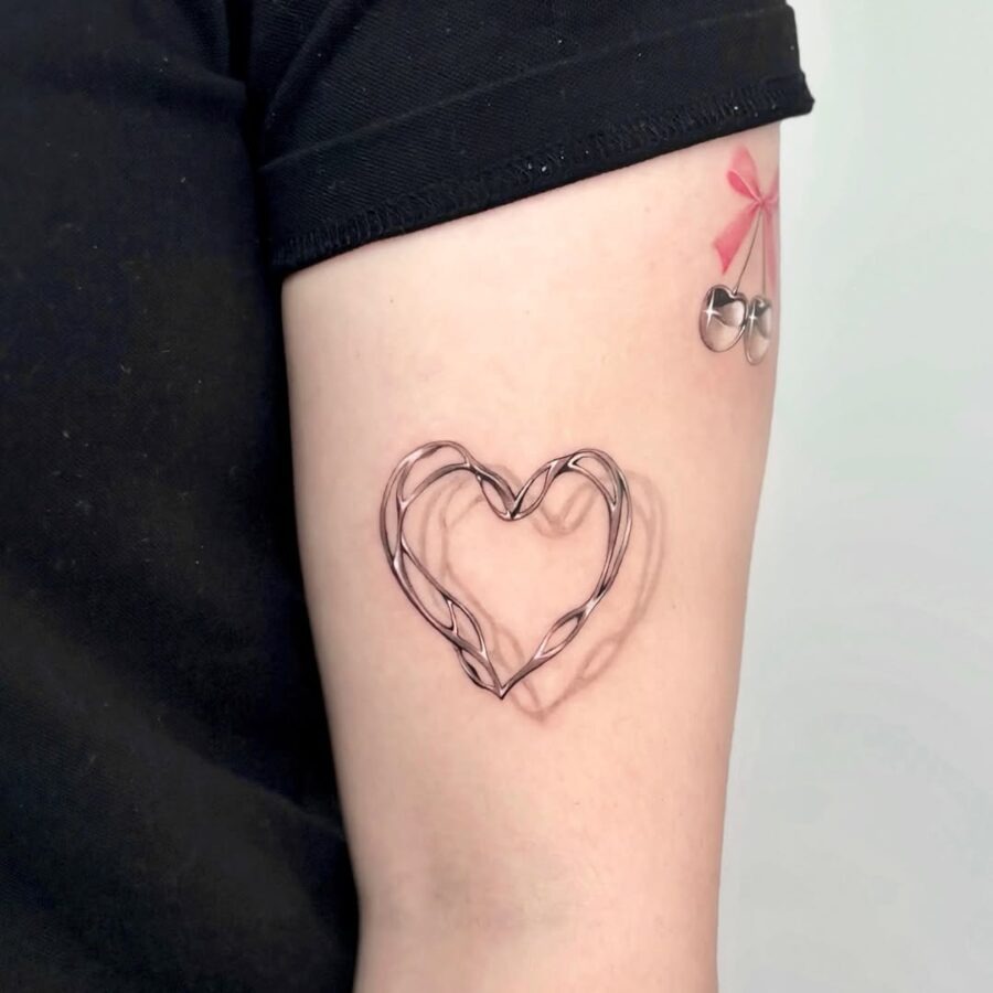 This tattoo features a creatively designed wire heart, giving it an artistic flair.