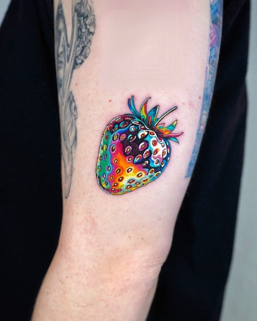 This colorful strawberry tattoo radiates a fun and playful energy.