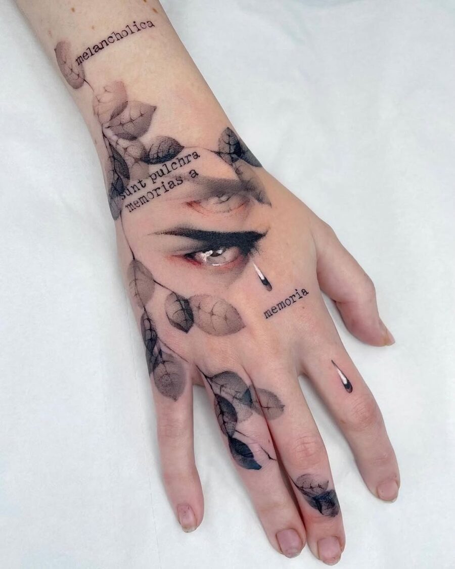 This tattoo showcases a playful cat intertwined with delicate butterflies and floral elements.