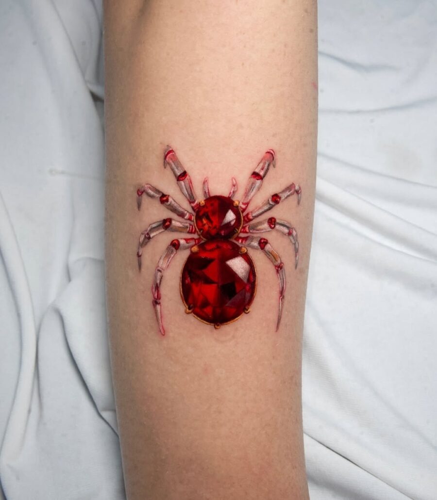 This tattoo showcases a stunning spider design with a gem-like appearance.