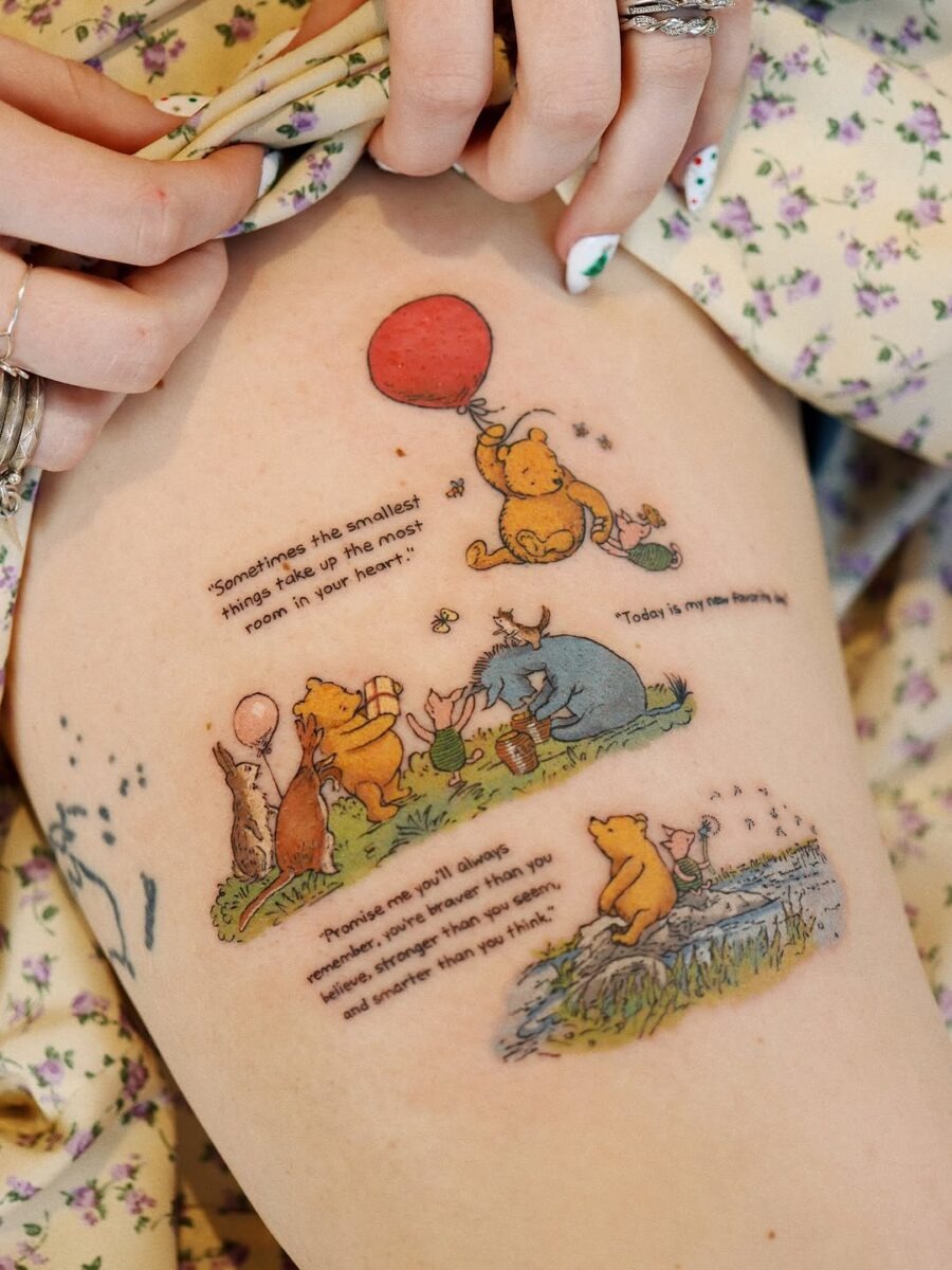 This tattoo features a charming illustration of Winnie the Pooh and friends.