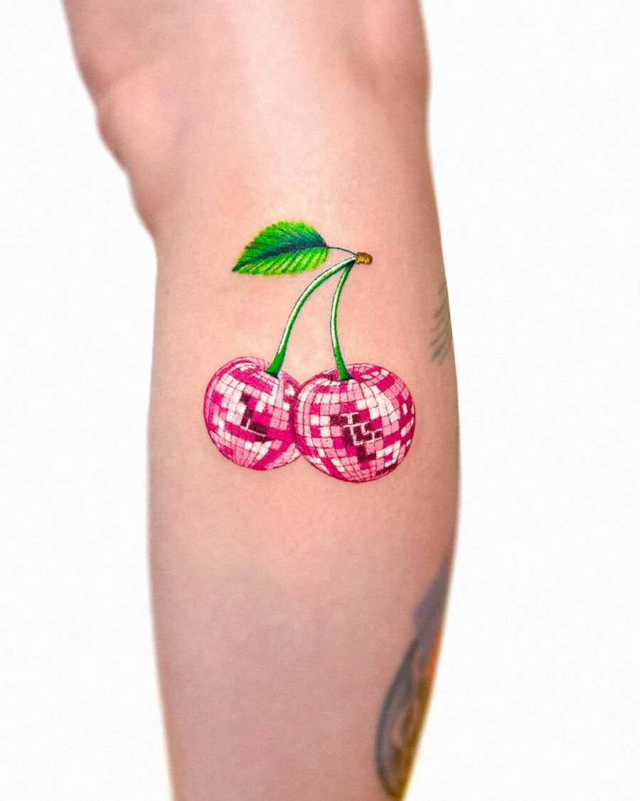 This cherry tattoo radiates energy and playful spirit.