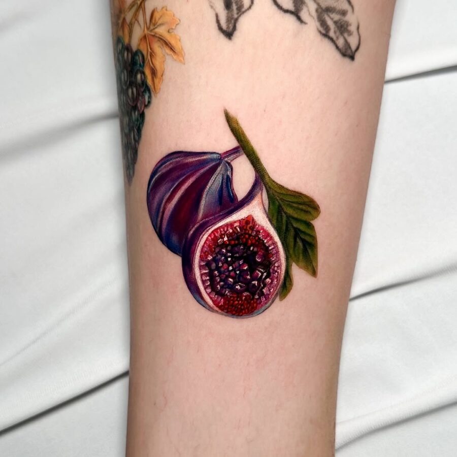This stunning fig tattoo features an intricate design with rich colors, showing its lush, textured surface.