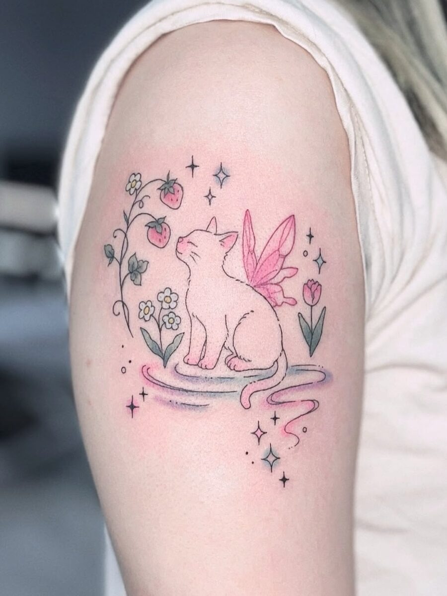 This enchanting tattoo showcases a serene cat adorned with delicate wings, surrounded by flowers and strawberries.