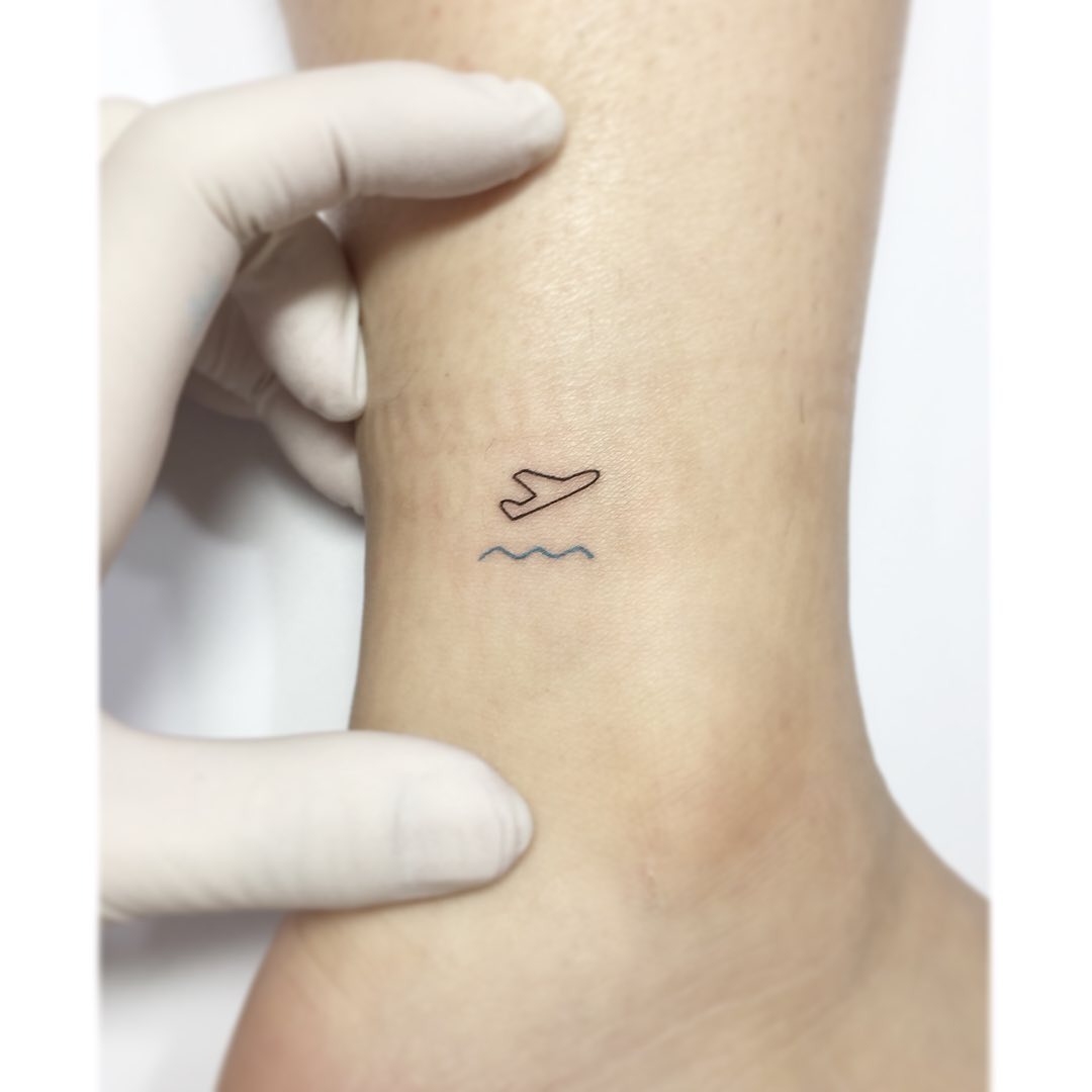 Charming minimalist airplane tattoo design Tattoo Design