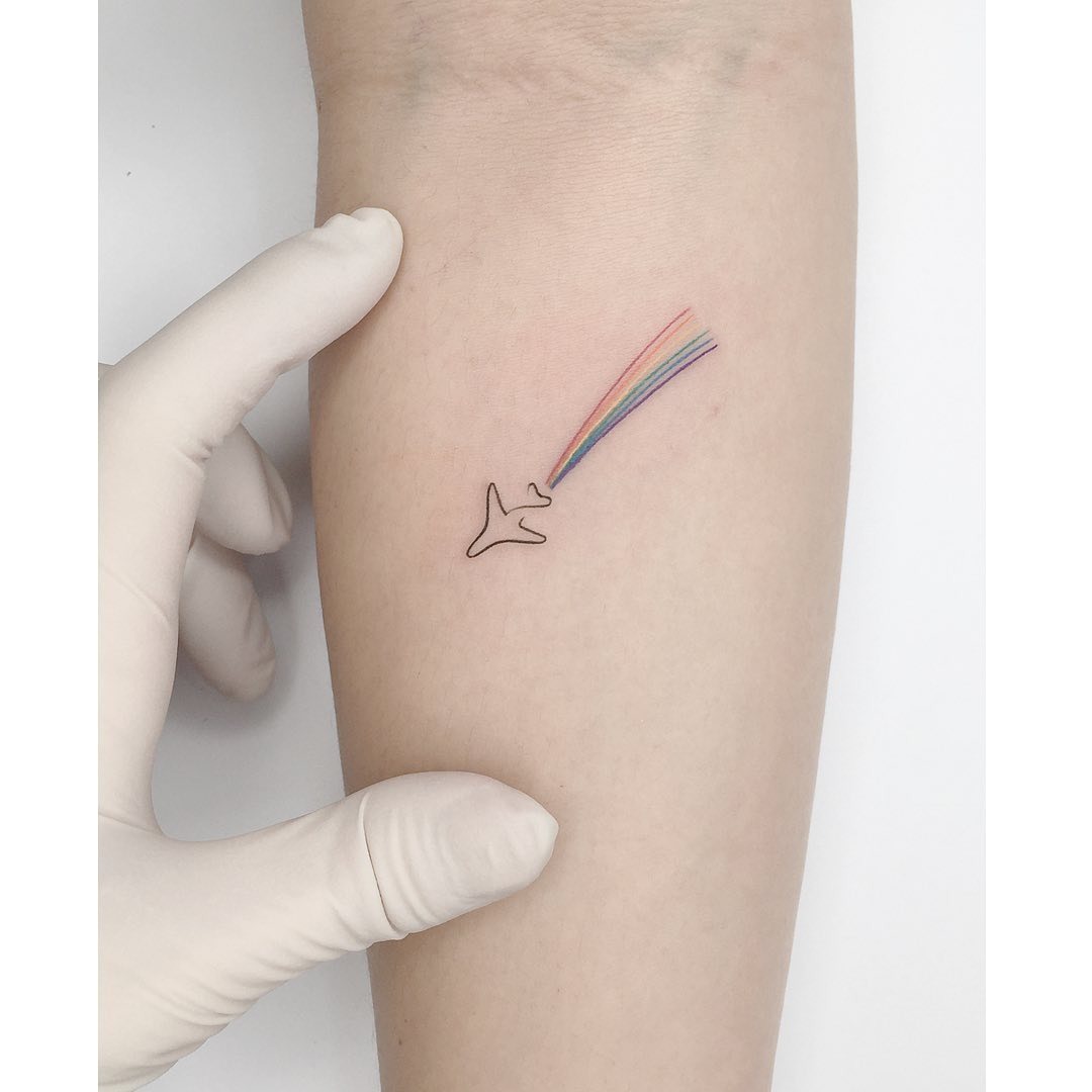 Colorful airplane tattoo with playful vibes Tattoo Design
