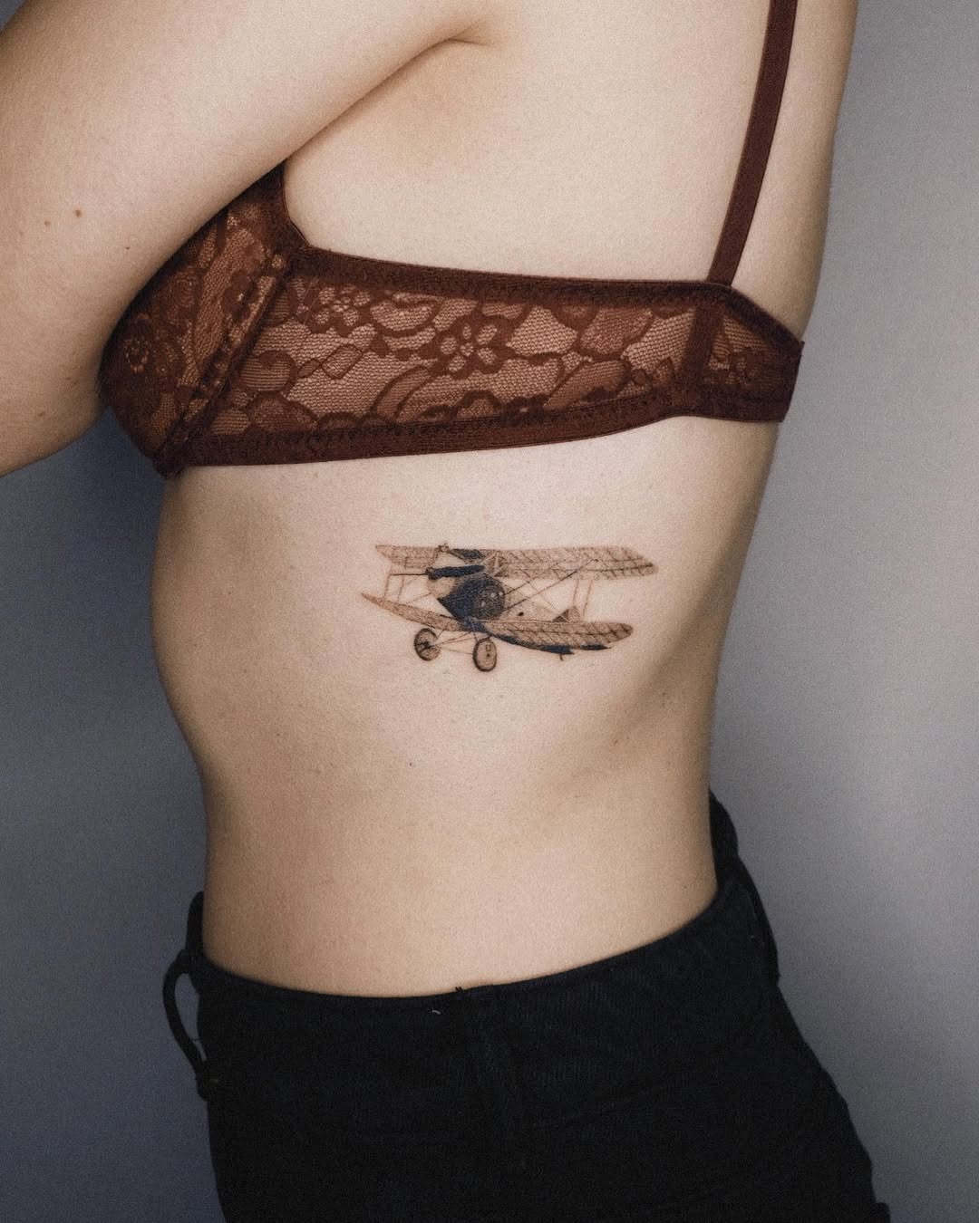 Elegant vintage airplane tattoo on the ribcage Tattoo Design