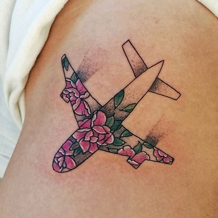 Floral airplane tattoo with vibrant colors. Tattoo Design