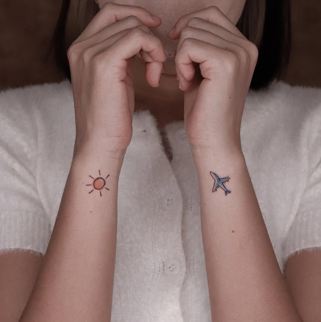 Minimalist airplane and sun tattoo on forearm Tattoo Design