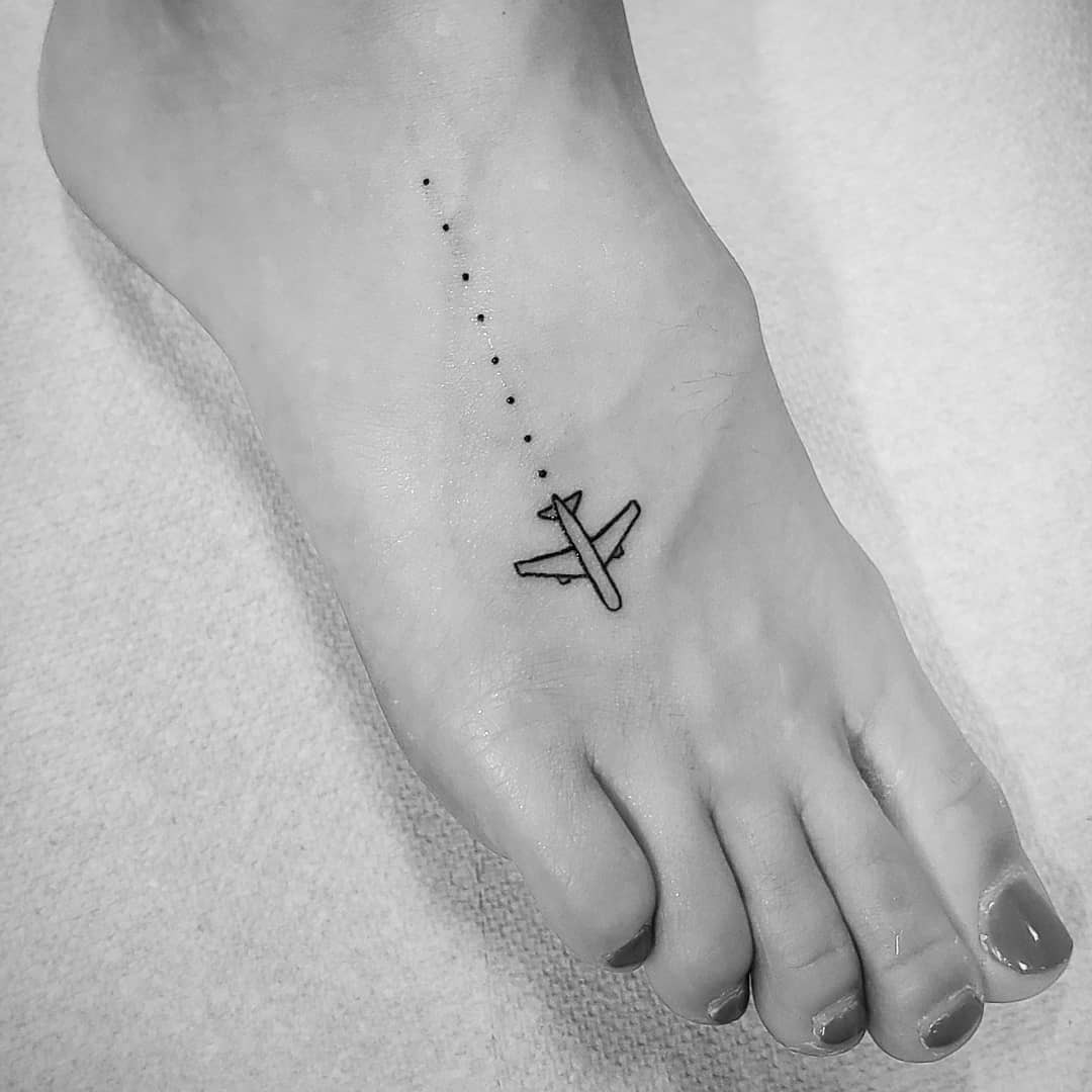 Minimalist airplane tattoo on foot Tattoo Design