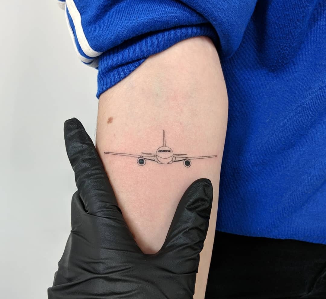 Minimalist airplane tattoo on the forearm Tattoo Design