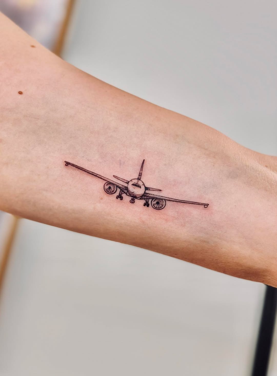 Minimalistic airplane tattoo with intricate details Tattoo Design