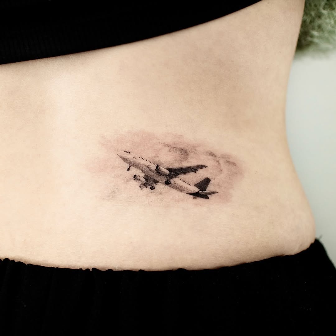 Stylish airplane tattoo for travel enthusiasts Tattoo Design