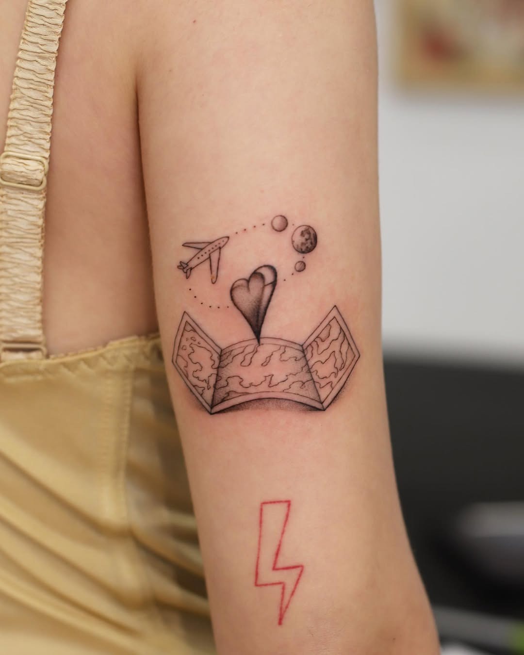 Whimsical airplane tattoo with heart and space theme Tattoo Design