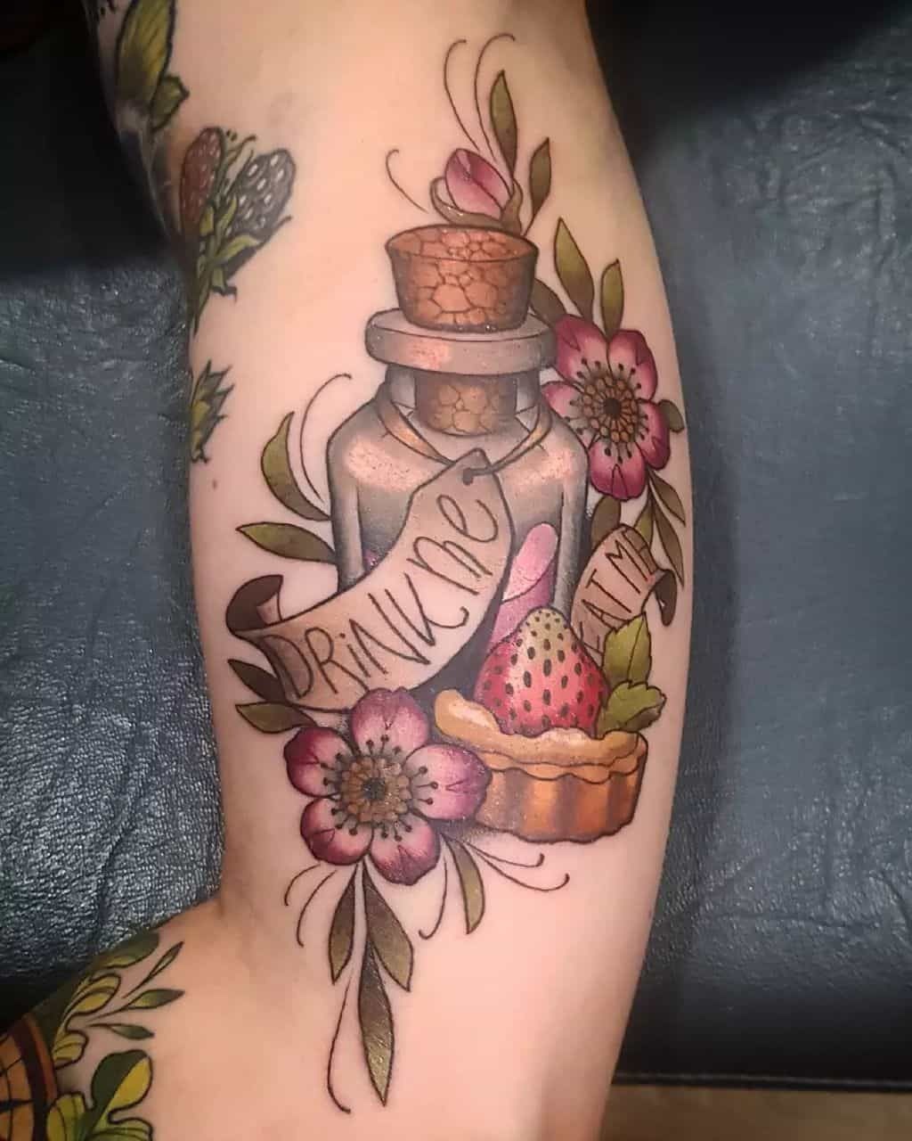 “Drink Me” Bottle With Flowers and Sweet Treats Tattoo Design