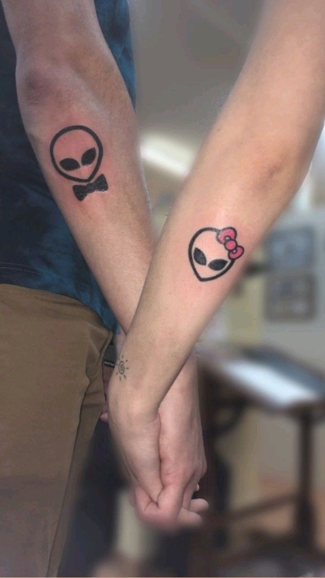 Matching Alien Couple Tattoos, a tattoo design rendered in clean detailed linework for the arm.