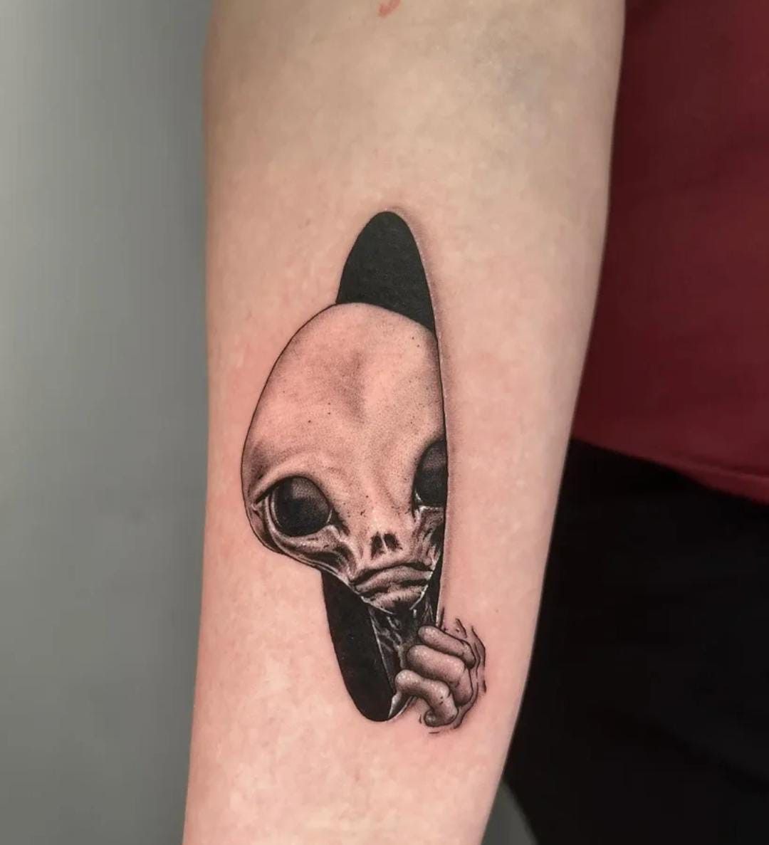 Peeking Alien Portal Tattoo, a tattoo design rendered in clean detailed linework for the arm.