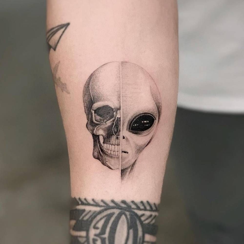Skull and Alien Split Face Tattoo, a tattoo design rendered in clean detailed linework.