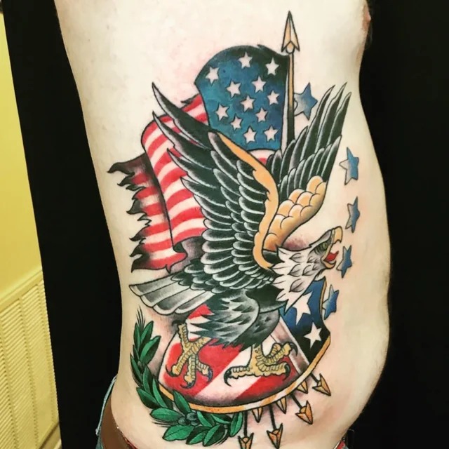 American traditional eagle tattoo with outstretched wings and patriotic stars and stripes banner