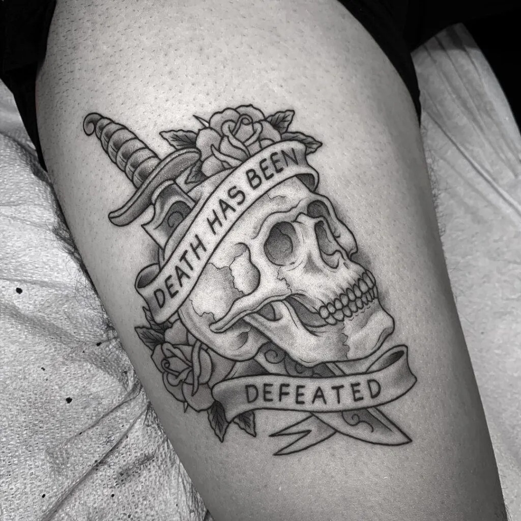Traditional cowboy skull tattoo wearing a wide brim hat and bandanna