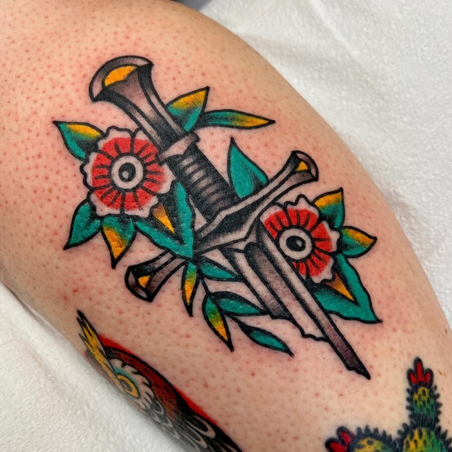 Bold Americana tattoo with dagger and flowers. Tattoo Design