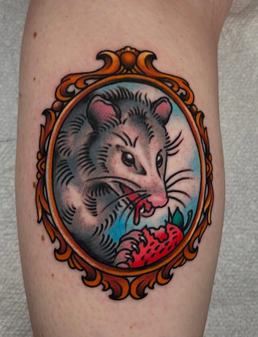 Charming opossum in a strawberry frame tattoo. Tattoo Design