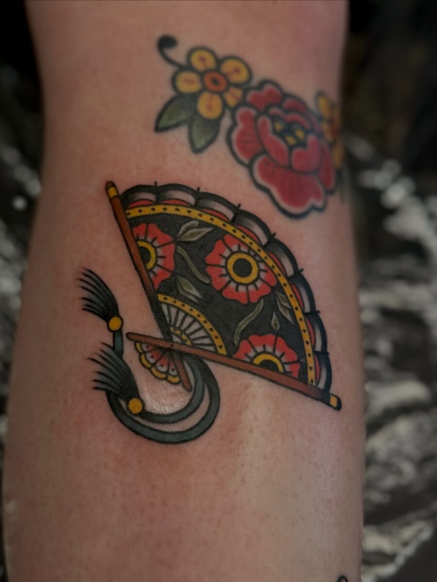 Vibrant Americana fan tattoo with floral accents Tattoo Design