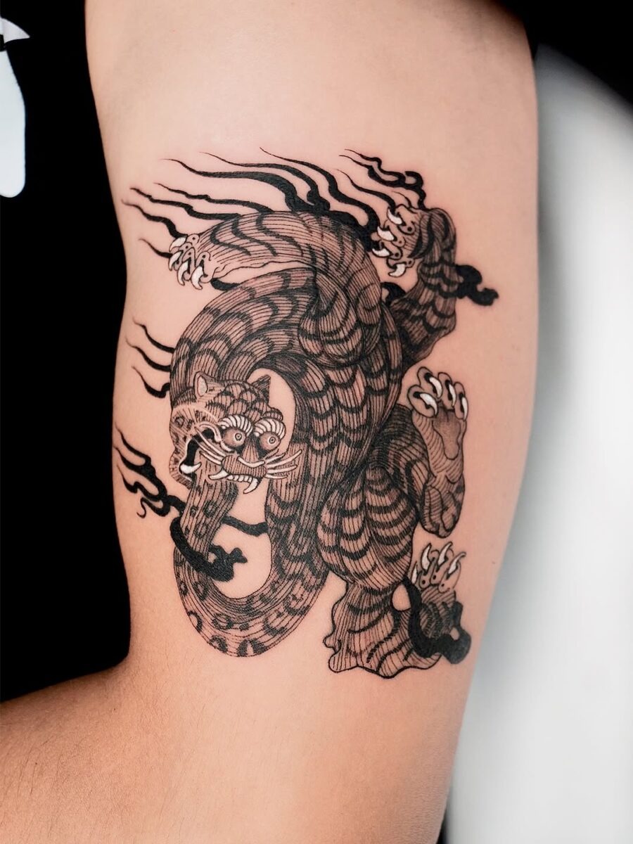 Intricate black ink dragon and tiger tattoo Tattoo Design