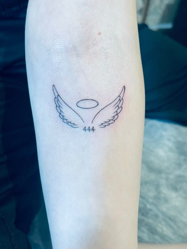 Combining the celestial with the numeric, this design shows 444 beneath a halo and two delicate wings.