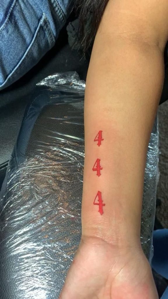 Bright red and stacked, this vertical 444 tattoo is a showstopper.