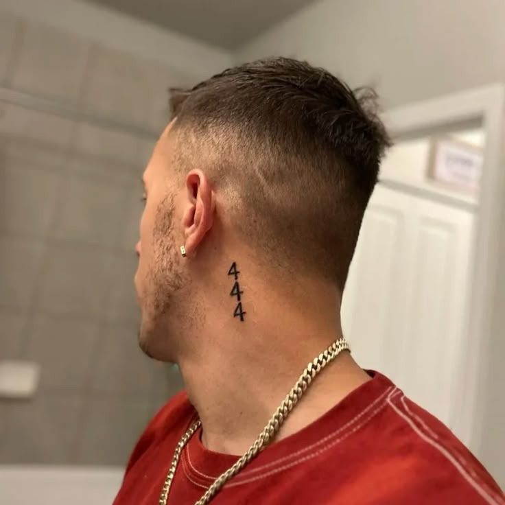 Tucked behind the ear, this vertical 444 tattoo is confident and edgy.