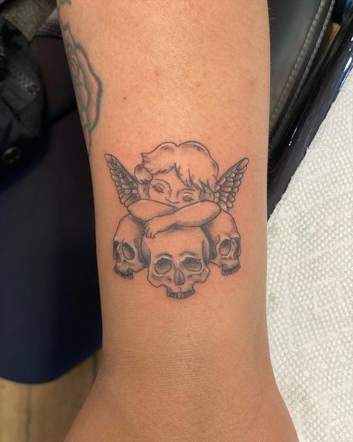 Cherub With Skulls Tattoo Tattoo Design