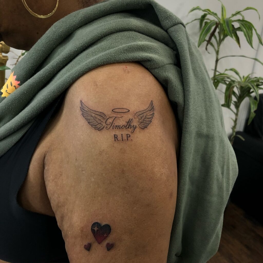 Minimal Angel Wings Memorial Tattoo with Date Tattoo Design